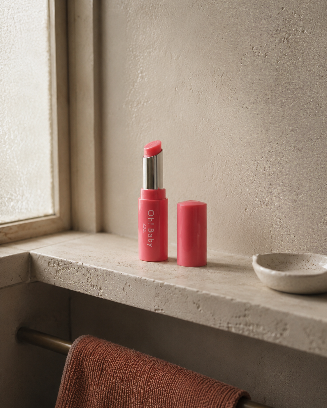 Oh! Baby lip balm shown open, soft peach-pink tint